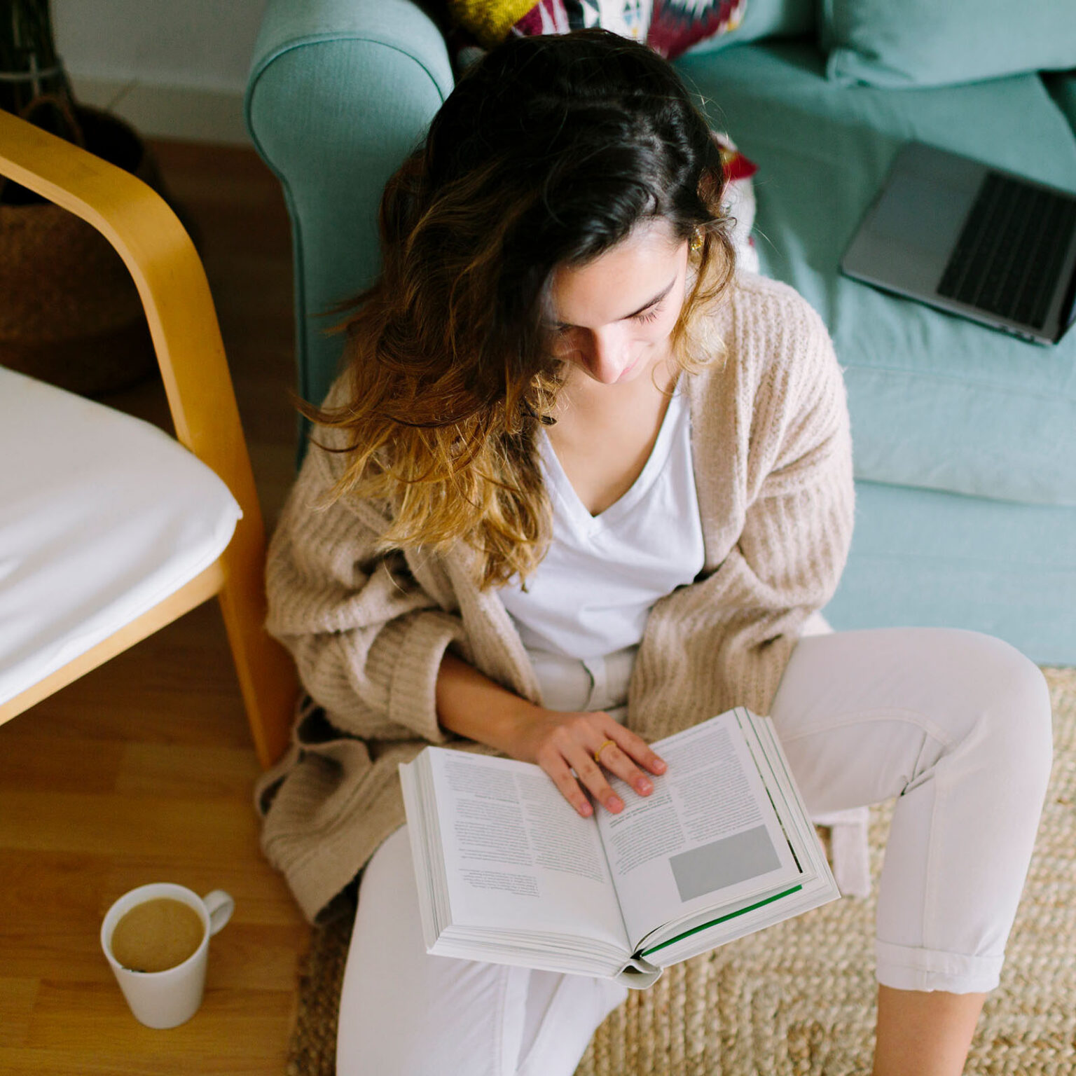 woman reading a book with coffee